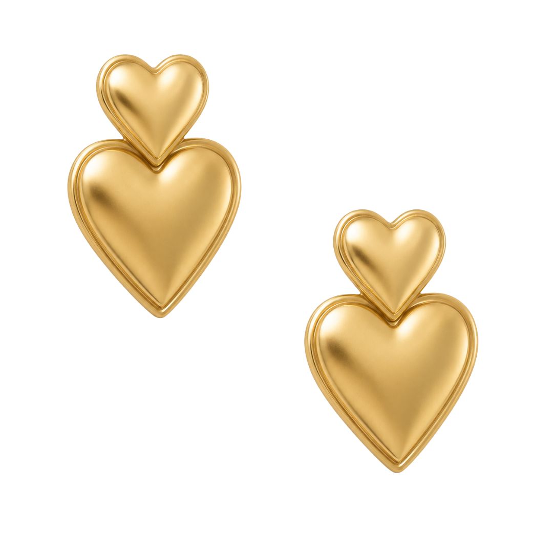 Polished gold-tone heart earrings flat lay